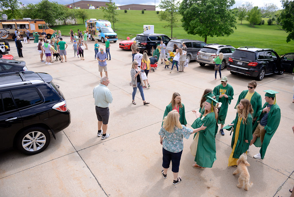 Graduates gather on Sunday at the Thornbrook Clubhouse after the drive-through graduation parade